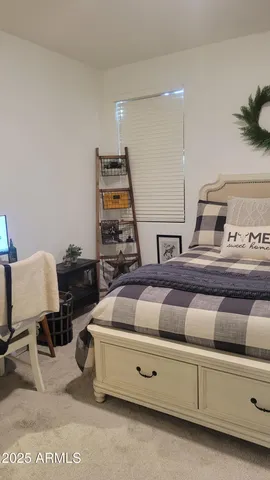 a bedroom with two beds and a lamp