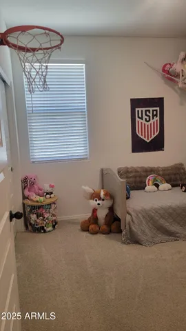 a bedroom with a bed and a couch