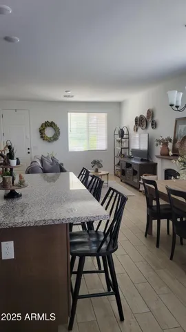a living room with furniture kitchen view and a table