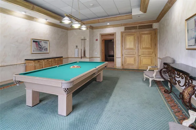 a room with pool table and windows