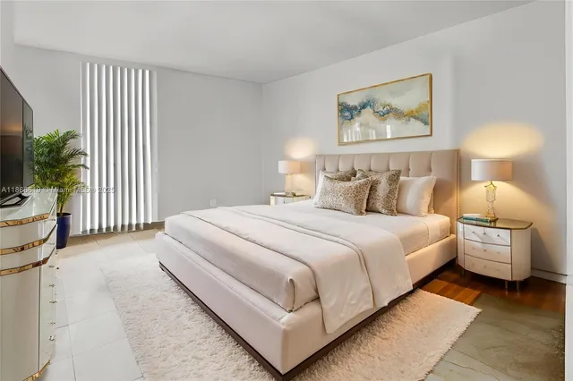 a bedroom with a bed and a painting on the wall