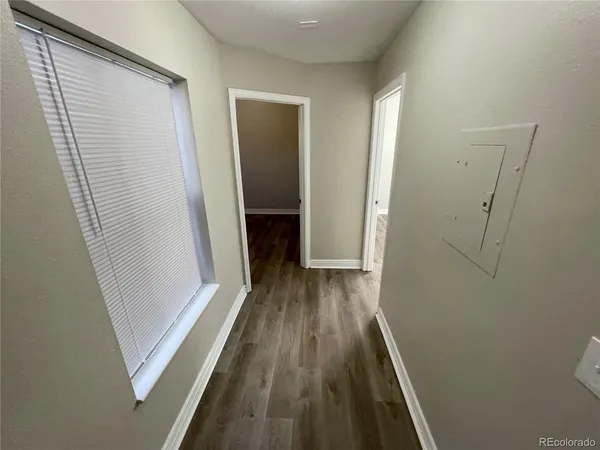 a view of a room with wooden floor and staircase