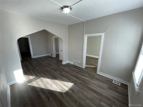 a living room with wooden floor and furniture
