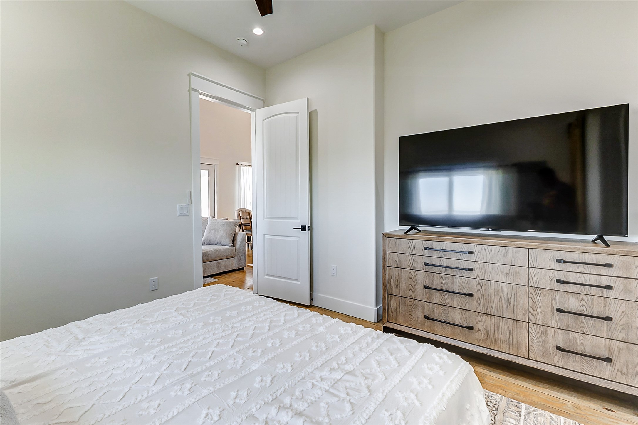 1395 Keith Avenue Port Bolivar, TX 77617 - Photo 24 of 38 a bedroom with a bed and a flat screen tv in white walls