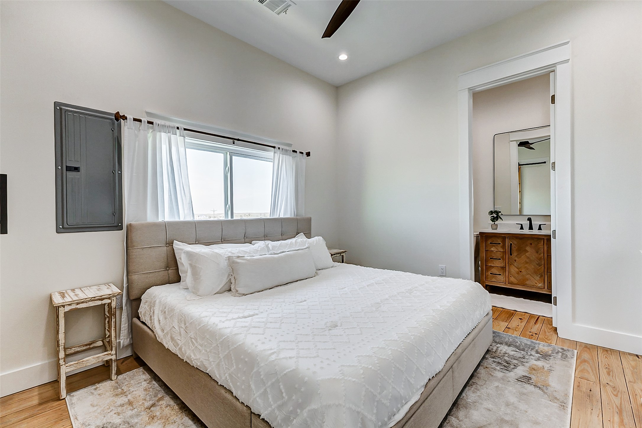 1395 Keith Avenue Port Bolivar, TX 77617 - Photo 28 of 38 a bedroom with a large bed and a chandelier