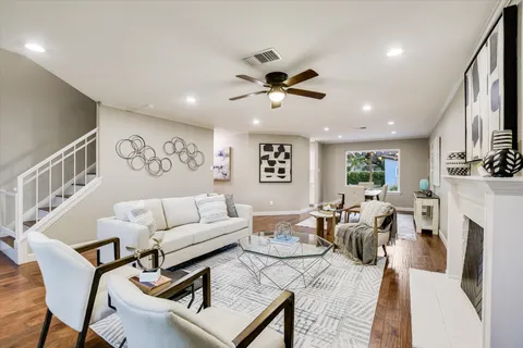 a living room with furniture a fireplace and a flat screen tv