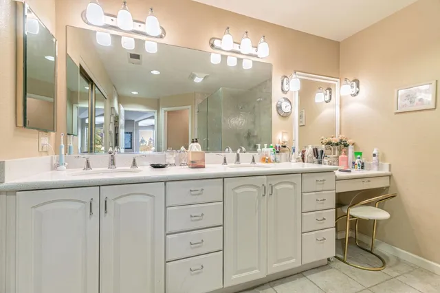 a bathroom with a sink vanity and mirror