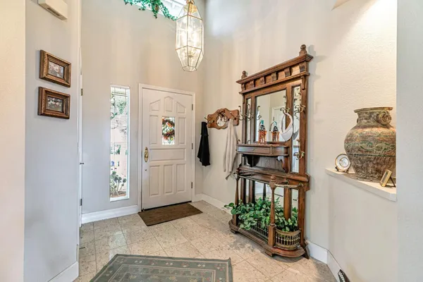 view of a hallway with windows and entryway