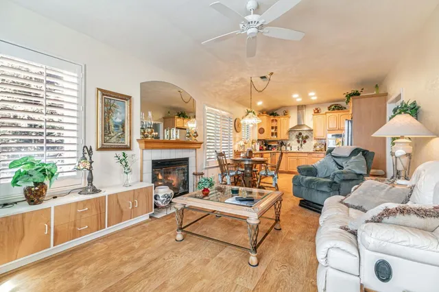 a living room with furniture a chandelier and a fireplace