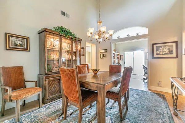 a view of a dining room with furniture and chandelier