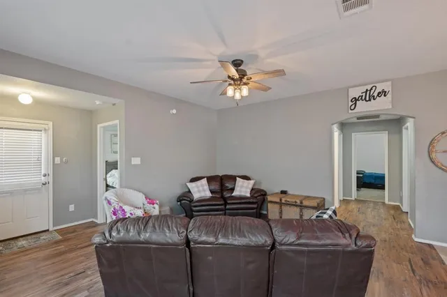 a living room with furniture and a chandelier