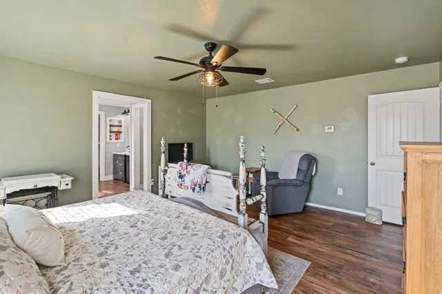 a bedroom with a bed a couch and dresser