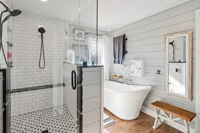 a bathroom with a sink a toilet a mirror and shower