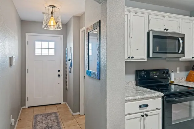 a kitchen with stainless steel appliances granite countertop a stove a microwave and a refrigerator