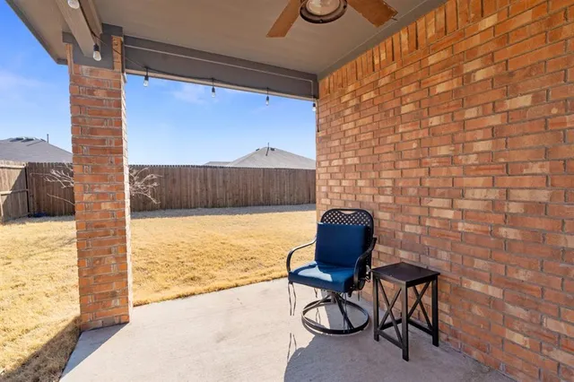 a view of a chairs and table in patio with a lake view