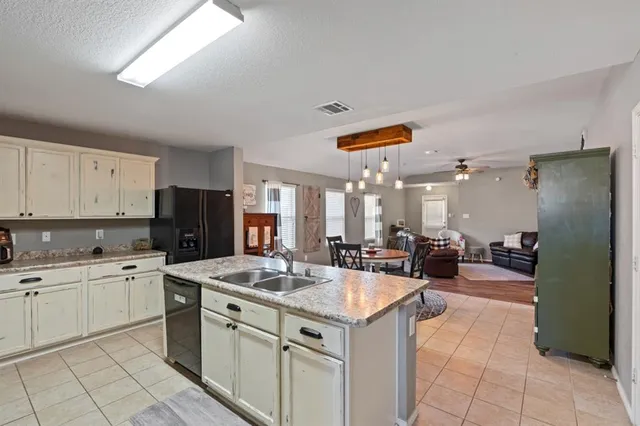 a kitchen with sink and refrigerator