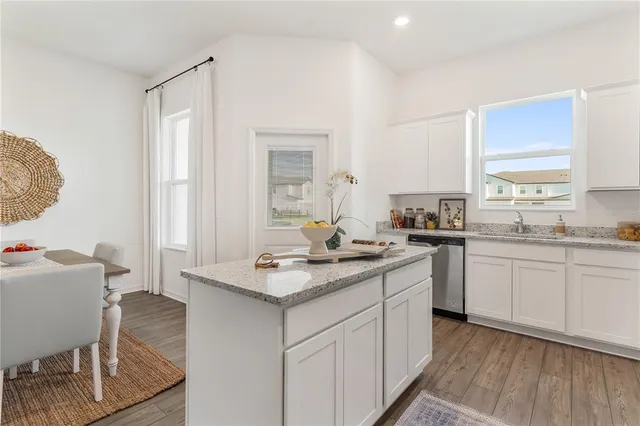 a kitchen with a sink cabinets and window