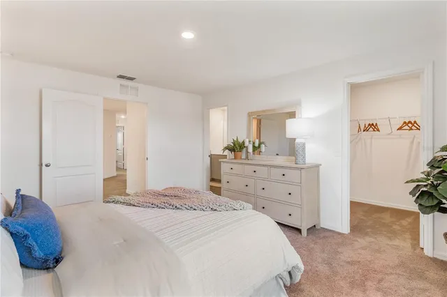 a bedroom with a bed and a dresser