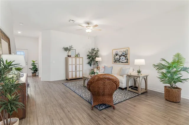 a living room with furniture and a potted plant