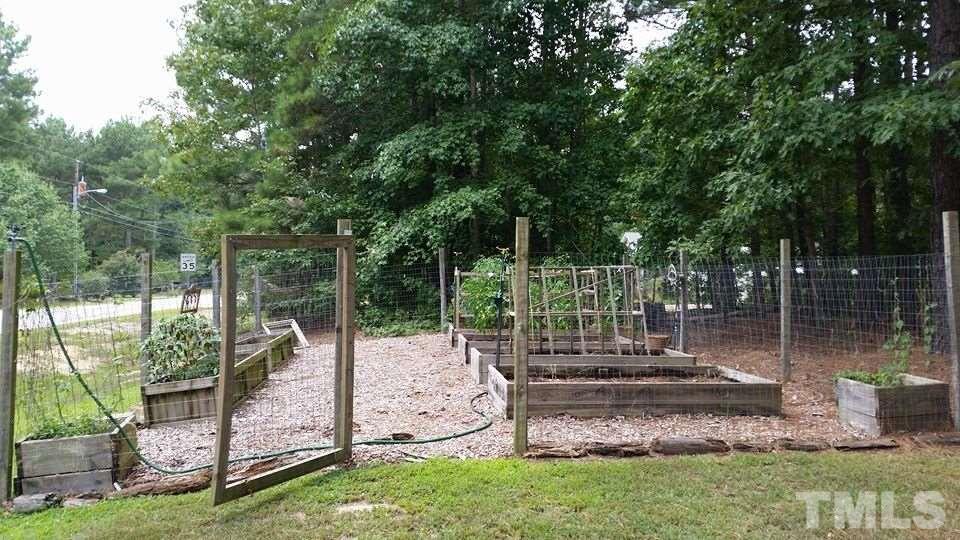 7253 Shawan Road Wendell, NC 27591 - Photo 3 of 16 Raised beds, fully fenced/gated from wildlife, has watering system! Grow your own herbs/veggies