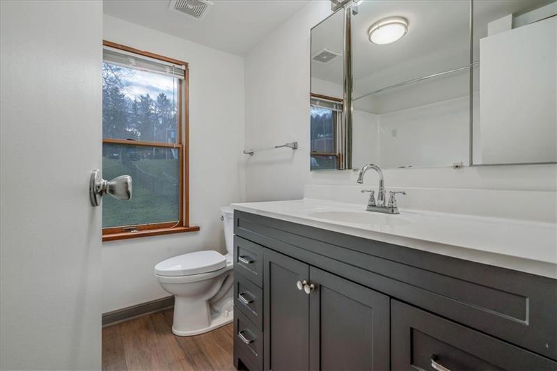 2057 Washington Road, Unit B Pittsburgh, PA 15241 - Photo 7 of 9 a bathroom with a sink a toilet a shower and a mirror