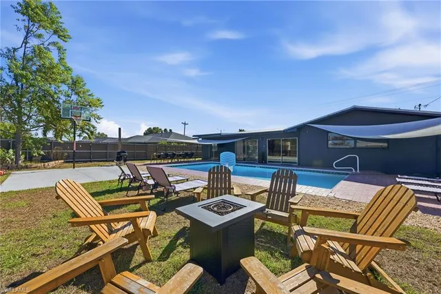 a view of a patio with table and chairs with wooden floor and fence