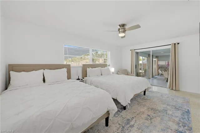 a bedroom with two beds and painting on the wall