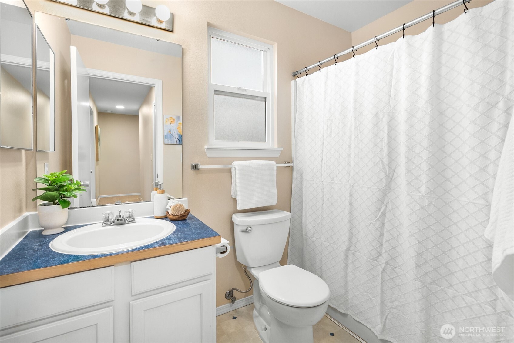 17639 Stanton Street Southeast Monroe, WA 98272 - Photo 13 of 24 a bathroom with a sink a toilet and shower curtain