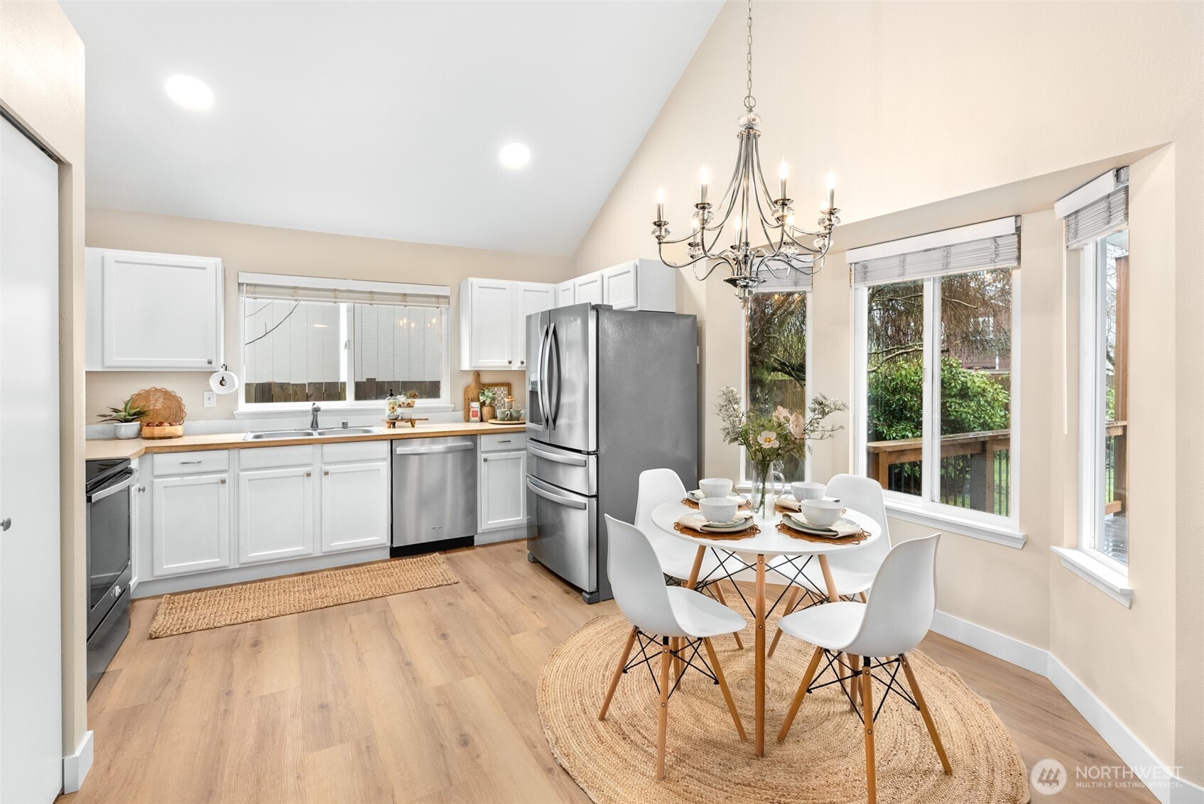 17639 Stanton Street Southeast Monroe, WA 98272 - Photo 4 of 24 a kitchen with a table chairs refrigerator and microwave