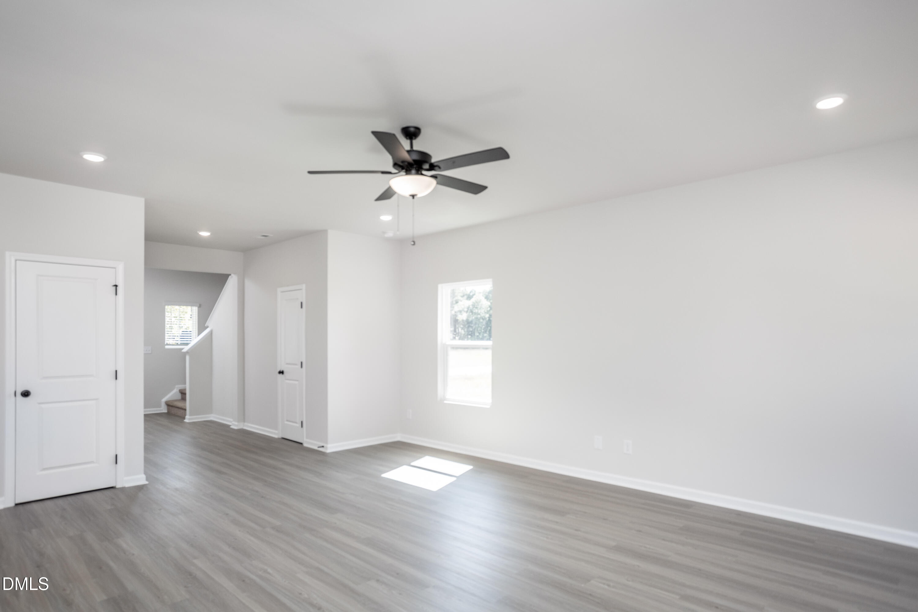 76 Foxton Place Angier, NC 27501 - Photo 3 of 13 a view of an empty room with wooden floor and a window