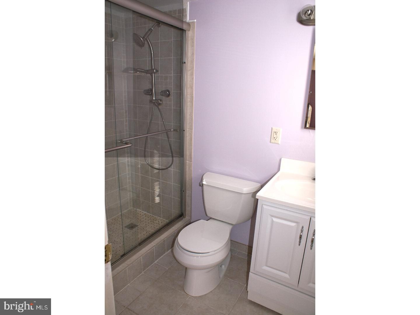 64 Welsh Tract Road, Unit 301 Newark, DE 19713 - Photo 11 of 15 a white toilet sitting next to a bathroom sink