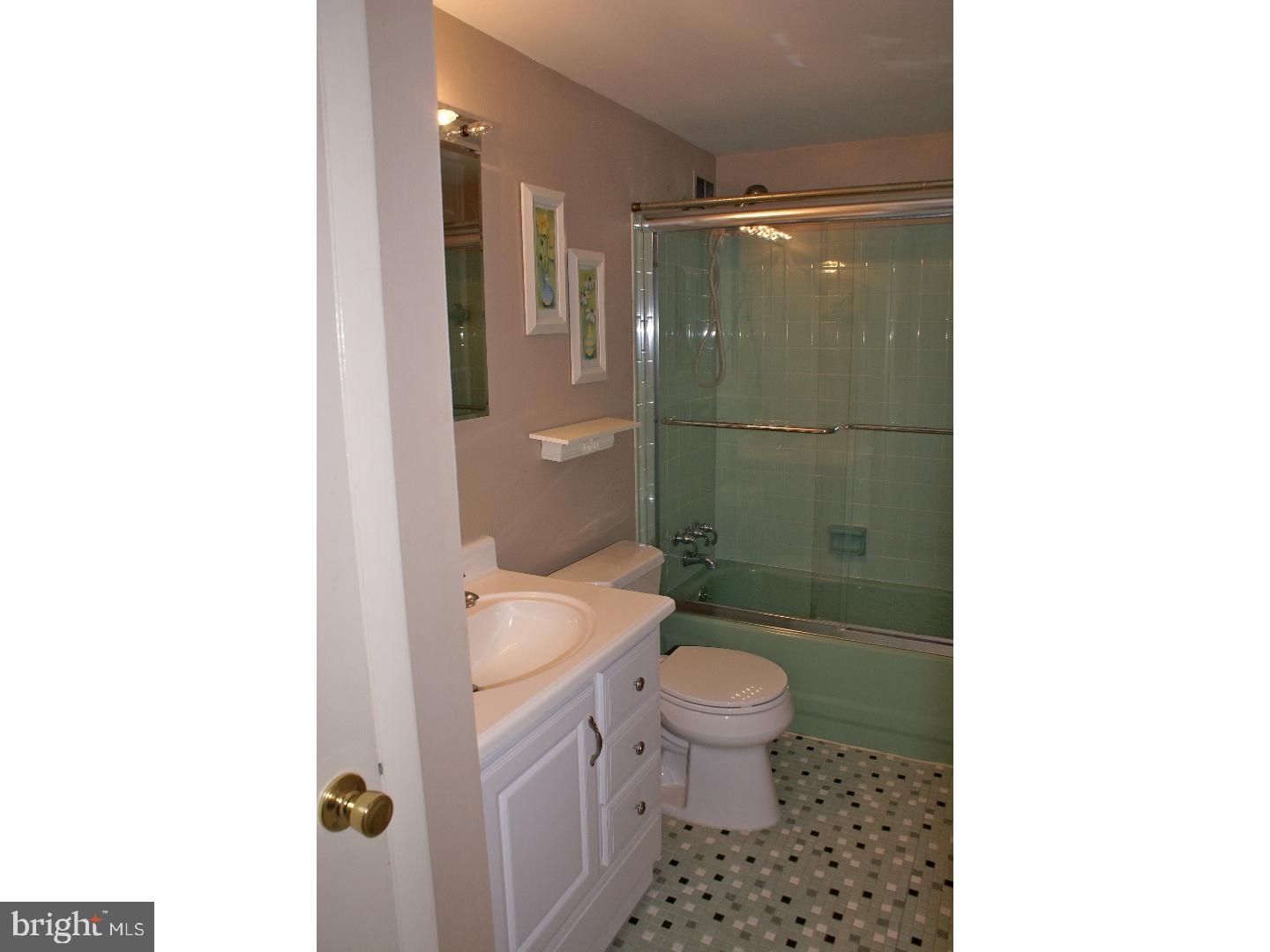 64 Welsh Tract Road, Unit 301 Newark, DE 19713 - Photo 13 of 15 a bathroom with a sink a toilet and shower