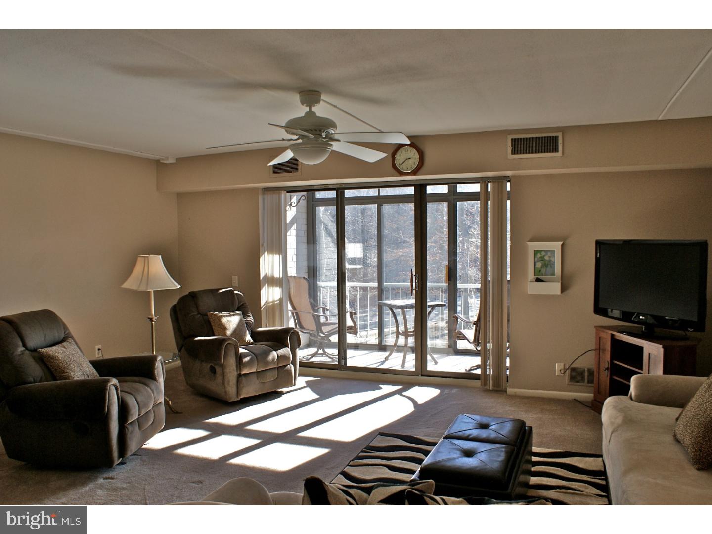 64 Welsh Tract Road, Unit 301 Newark, DE 19713 - Photo 4 of 15 a living room with furniture and a flat screen tv