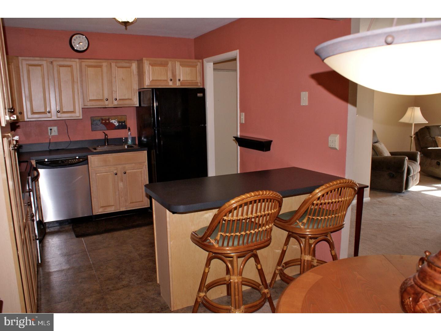64 Welsh Tract Road, Unit 301 Newark, DE 19713 - Photo 7 of 15 a kitchen with stainless steel appliances granite countertop a refrigerator a stove a sink and dishwasher