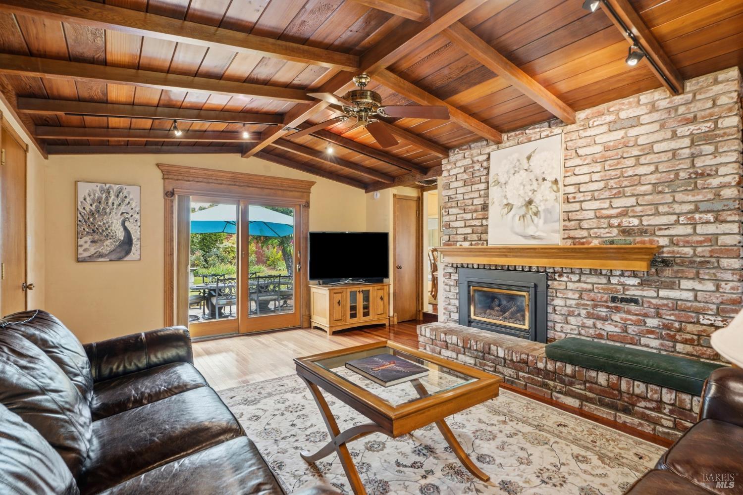 373 Piezzi Road Santa Rosa, CA 95401 - Photo 12 of 55 a living room with furniture a flat screen tv and a fireplace