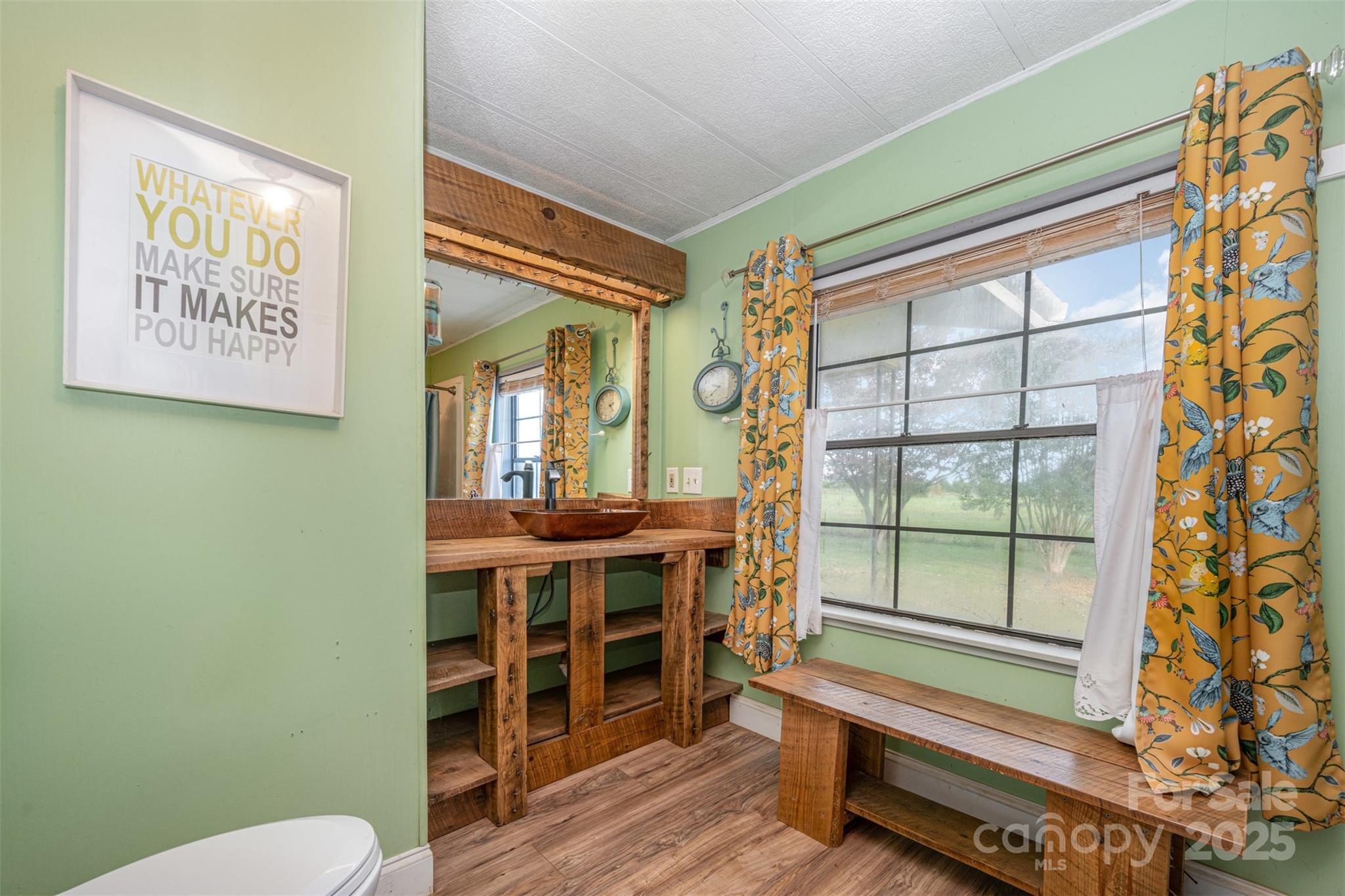 316 Josey Road Statesville, NC 28625 - Photo 14 of 27 a view of a bathroom with a window and wooden floor
