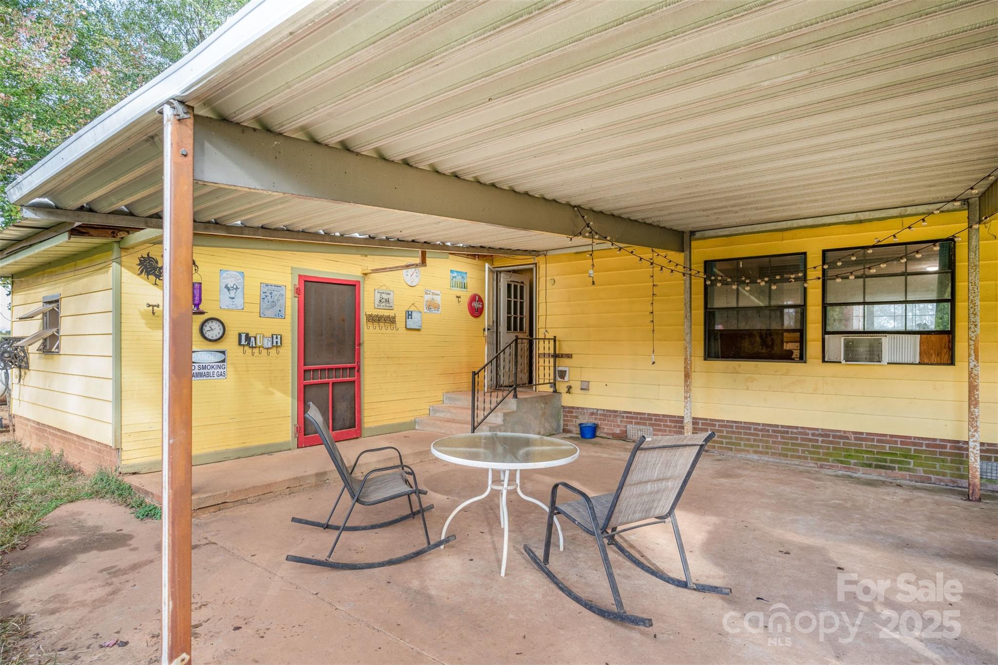 316 Josey Road Statesville, NC 28625 - Photo 16 of 27 a outdoor space with the couches and dining table under the umbrella