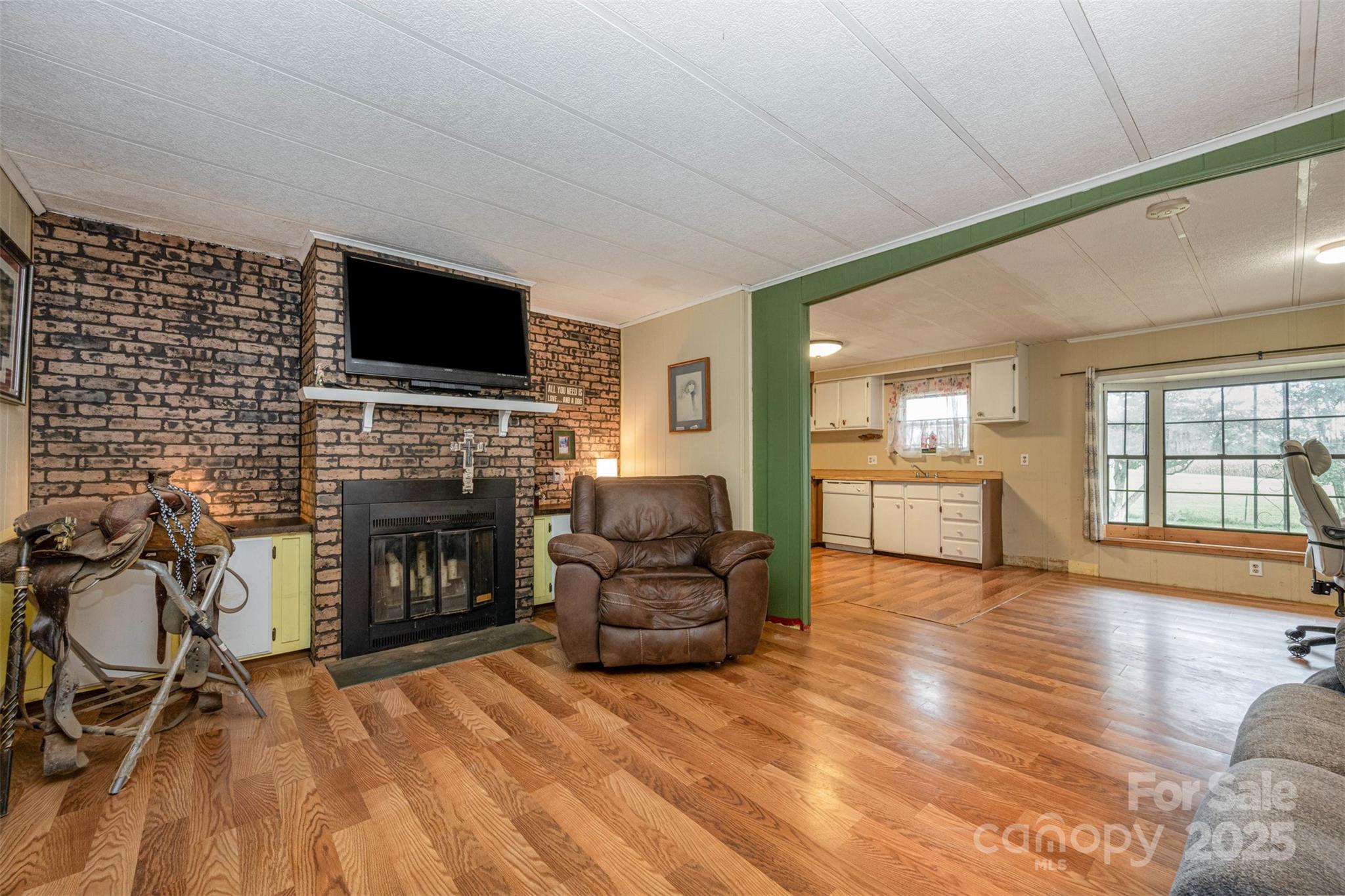 316 Josey Road Statesville, NC 28625 - Photo 4 of 27 a living room with furniture a flat screen tv and a fireplace