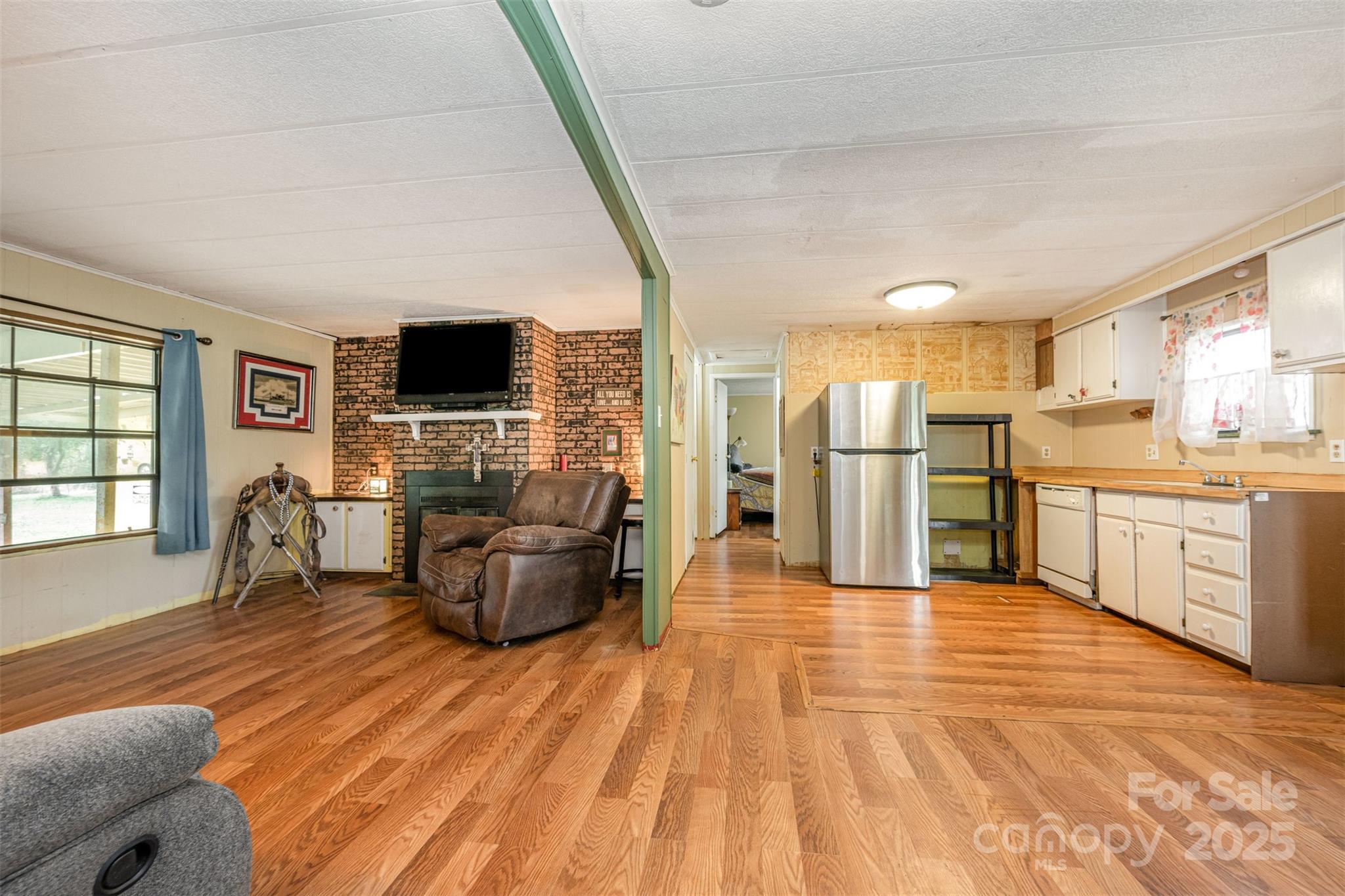 316 Josey Road Statesville, NC 28625 - Photo 6 of 27 a living room with stainless steel appliances furniture and a flat screen tv