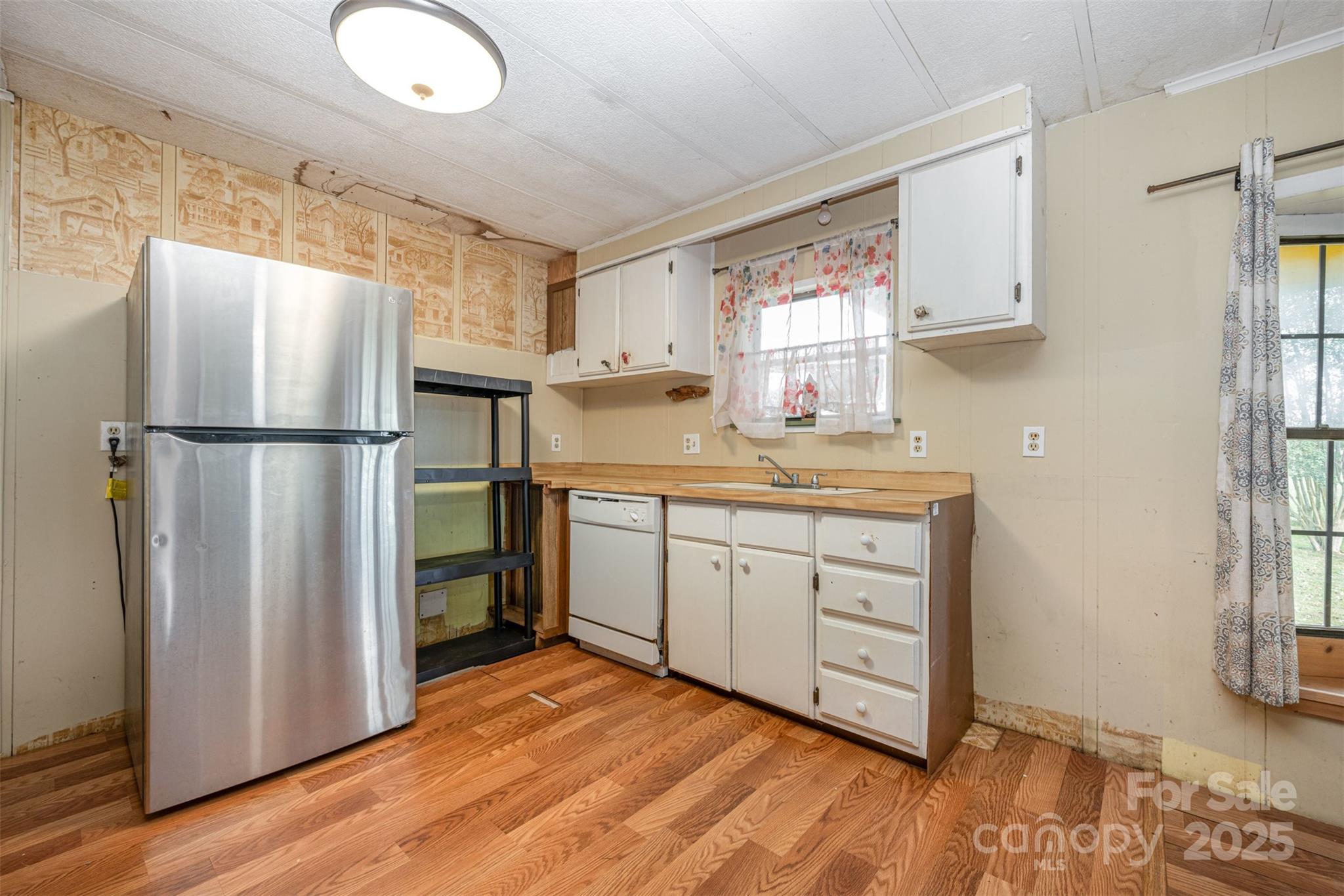 316 Josey Road Statesville, NC 28625 - Photo 7 of 27 a kitchen with a refrigerator sink stove and cabinets