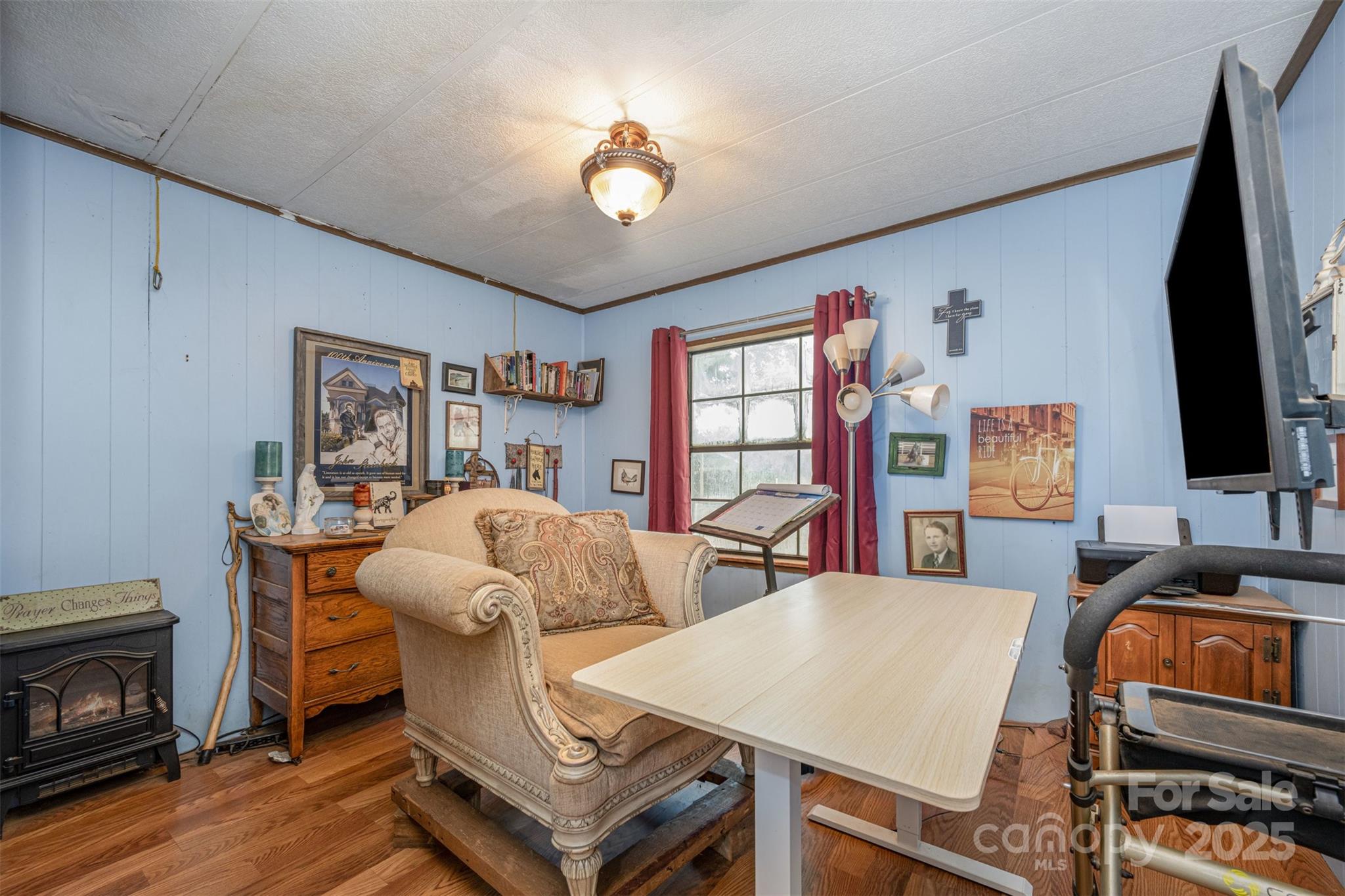 316 Josey Road Statesville, NC 28625 - Photo 10 of 27 a living room with furniture a flat screen tv and a fireplace