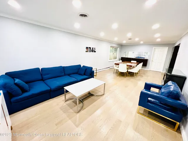 a living room with furniture and kitchen view