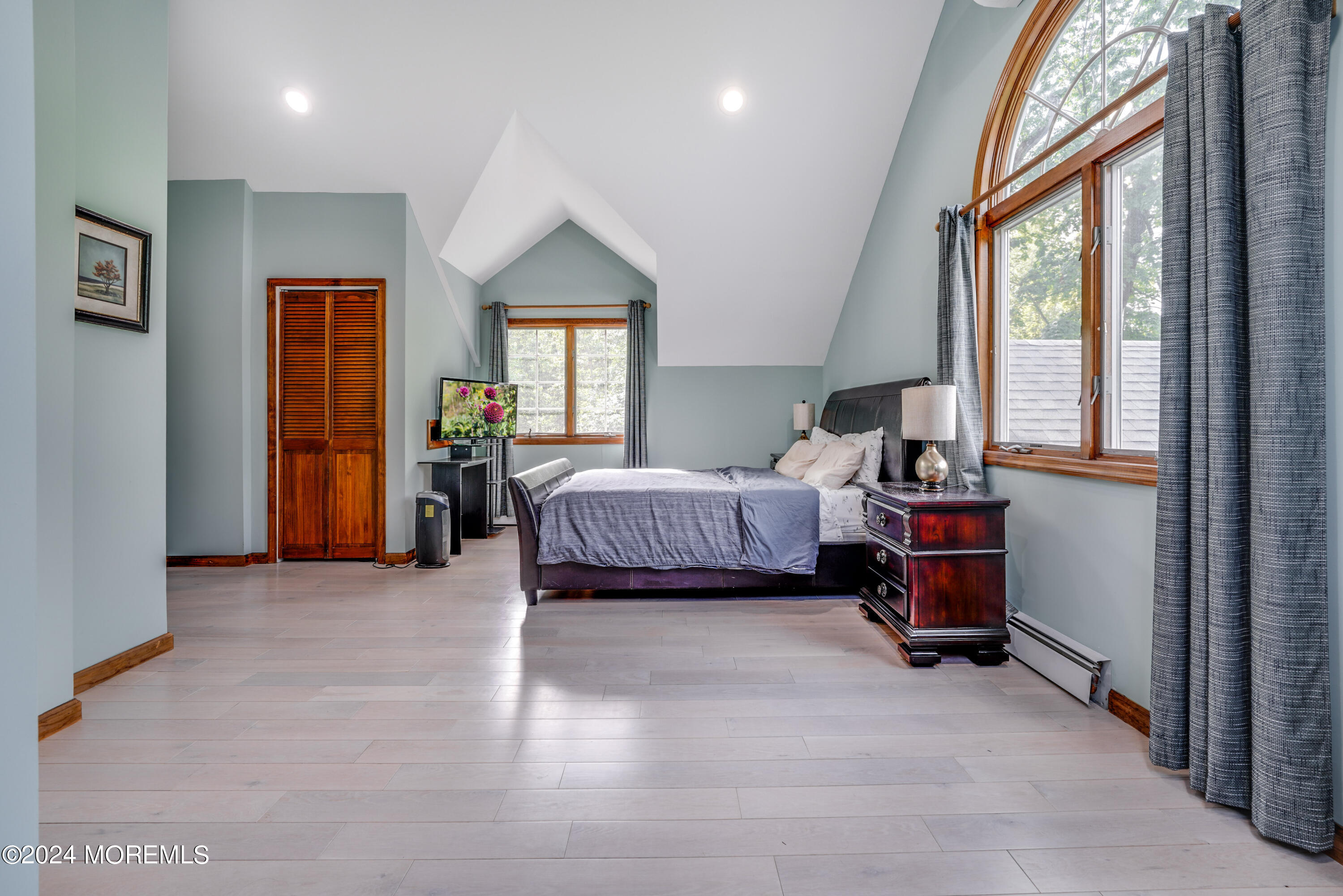 500 Locust Point Road Rumson, NJ 07760 - Photo 14 of 48 a spacious bedroom with a bed and a window