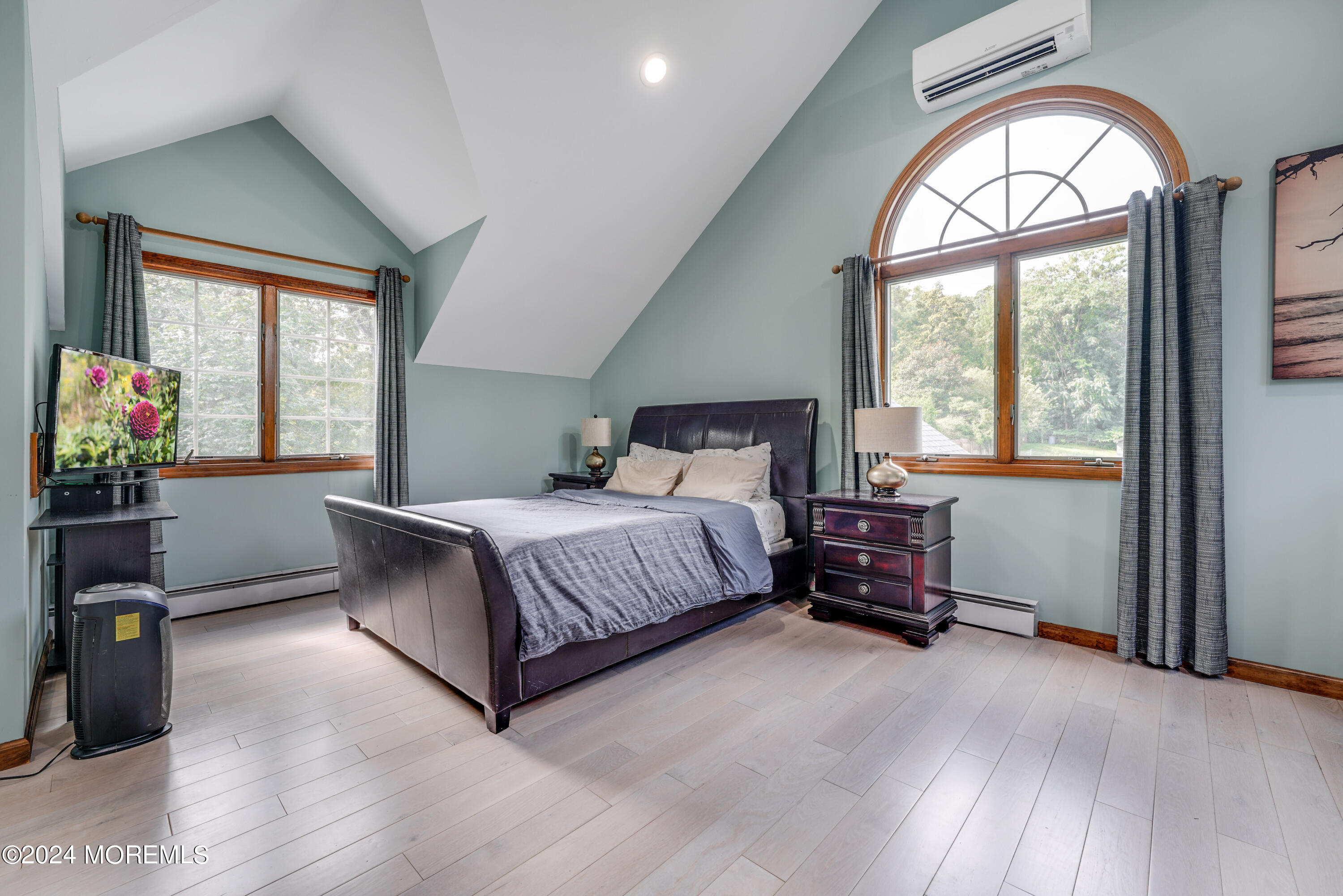 500 Locust Point Road Rumson, NJ 07760 - Photo 15 of 48 a bedroom with a bed painting on wall and windows