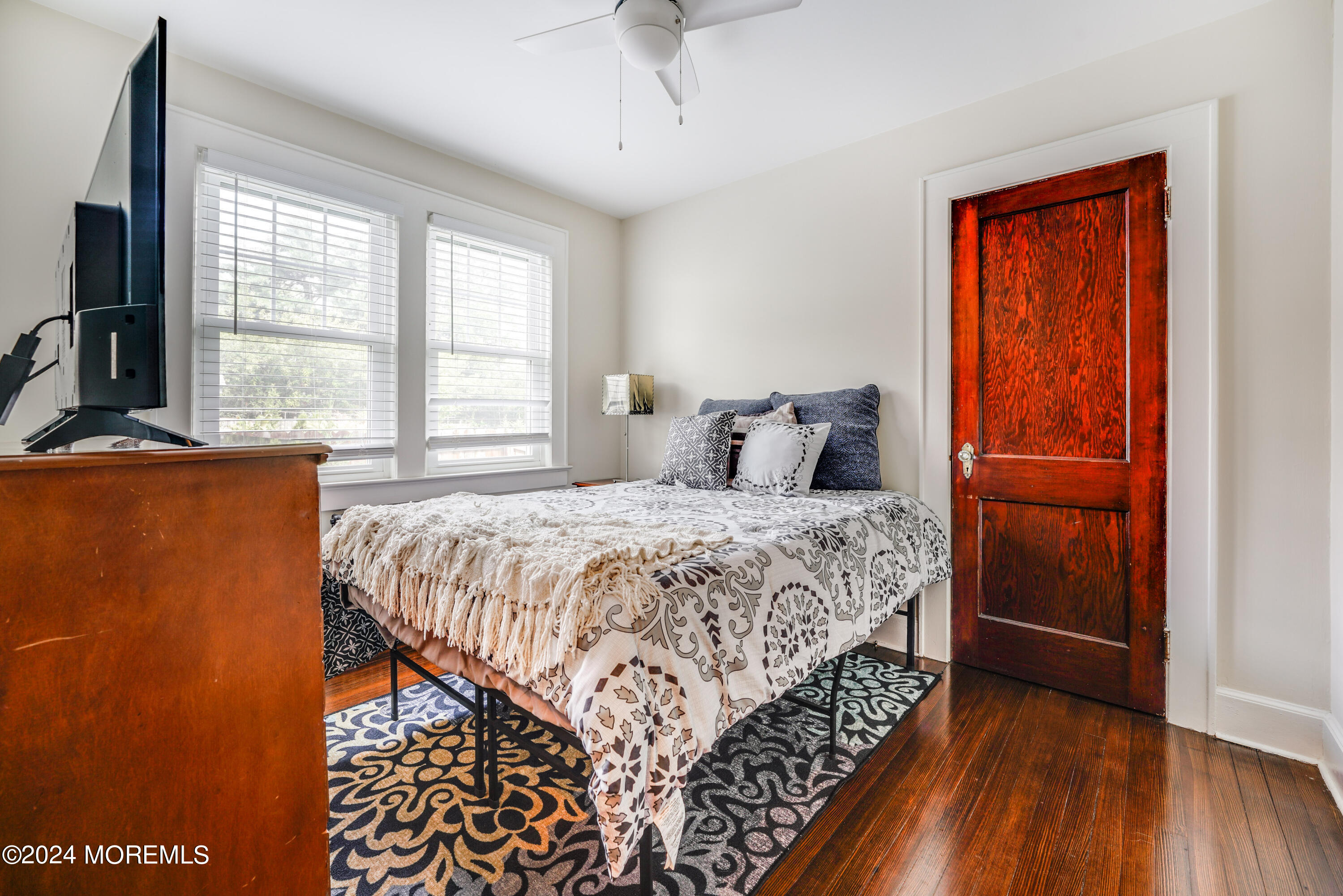 500 Locust Point Road Rumson, NJ 07760 - Photo 30 of 48 a bedroom with a bed and a dresser next to a window