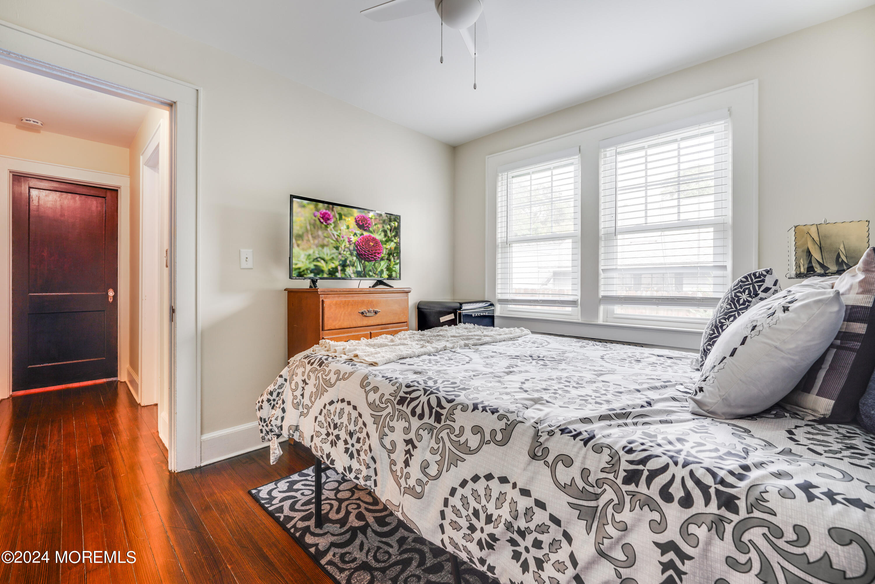 500 Locust Point Road Rumson, NJ 07760 - Photo 31 of 48 a bedroom with a bed and wooden floor