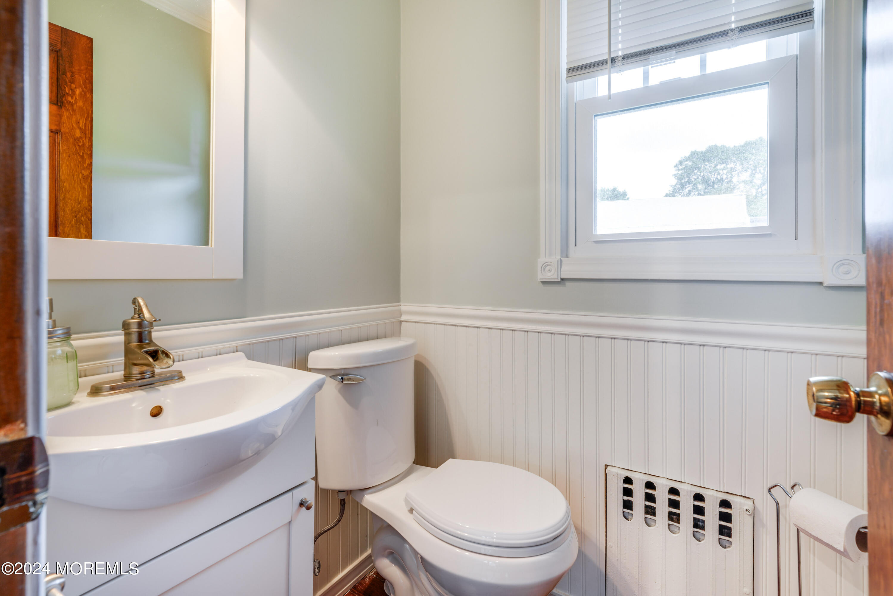 500 Locust Point Road Rumson, NJ 07760 - Photo 32 of 48 a bathroom with a sink a toilet and a window