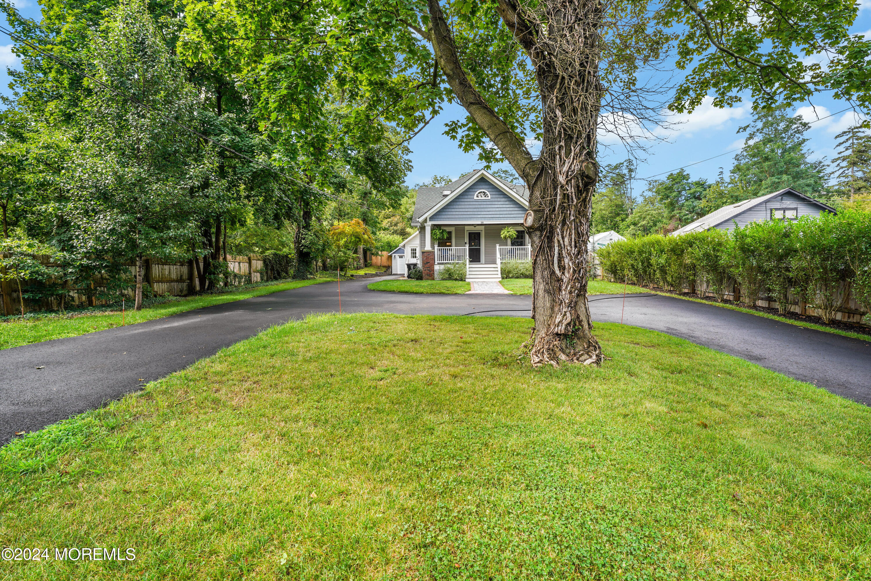 500 Locust Point Road Rumson, NJ 07760 - Photo 43 of 48 a front view of a house with yard and green space