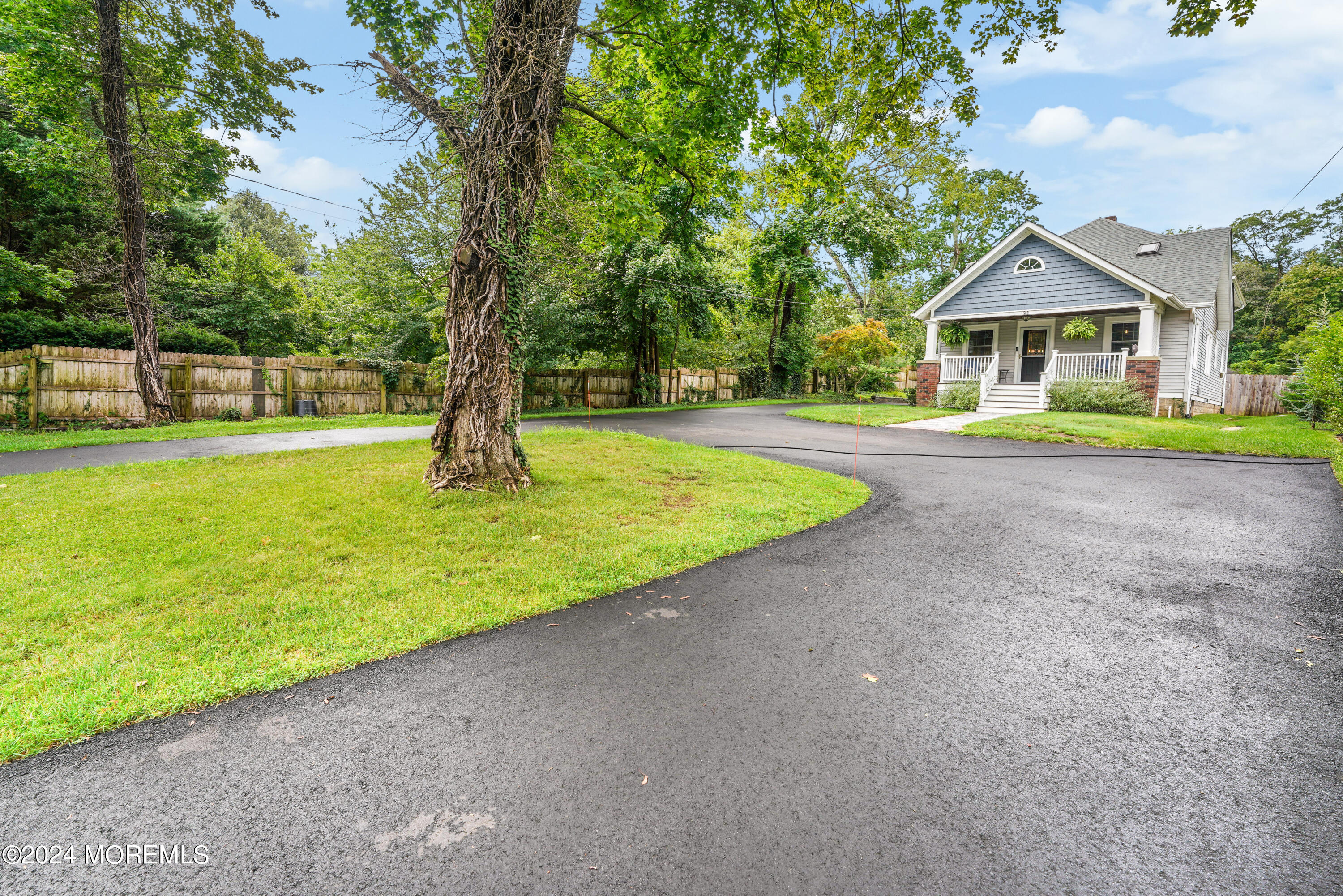 500 Locust Point Road Rumson, NJ 07760 - Photo 45 of 48 a front view of a house with a yard and trees