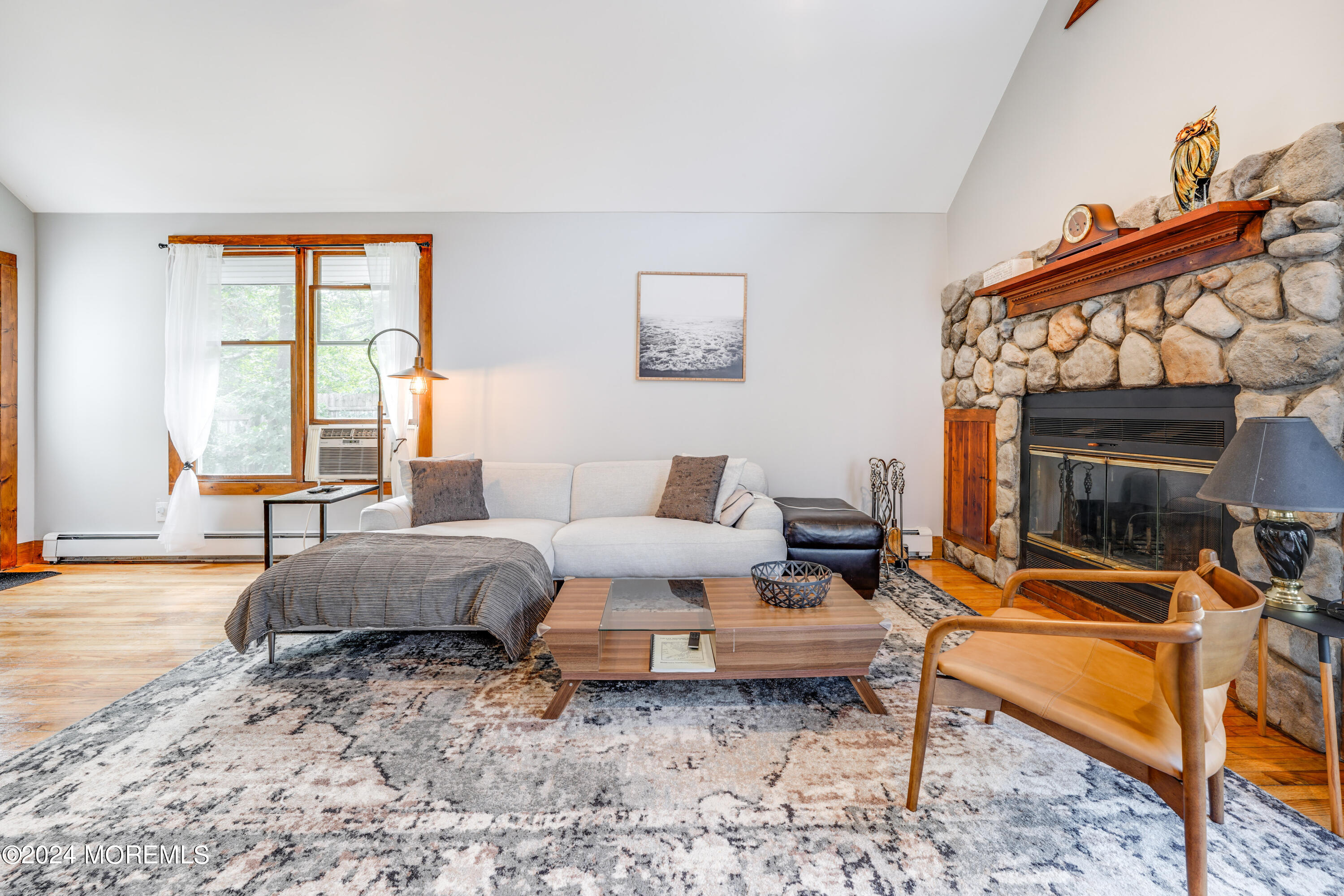 500 Locust Point Road Rumson, NJ 07760 - Photo 5 of 48 a living room with furniture a flat screen tv and a fireplace